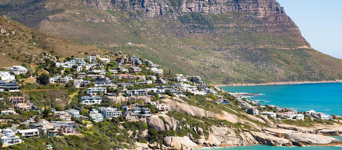 beautiful-shot-buildings-hill-turquoise-beach-cape-town-south-africa